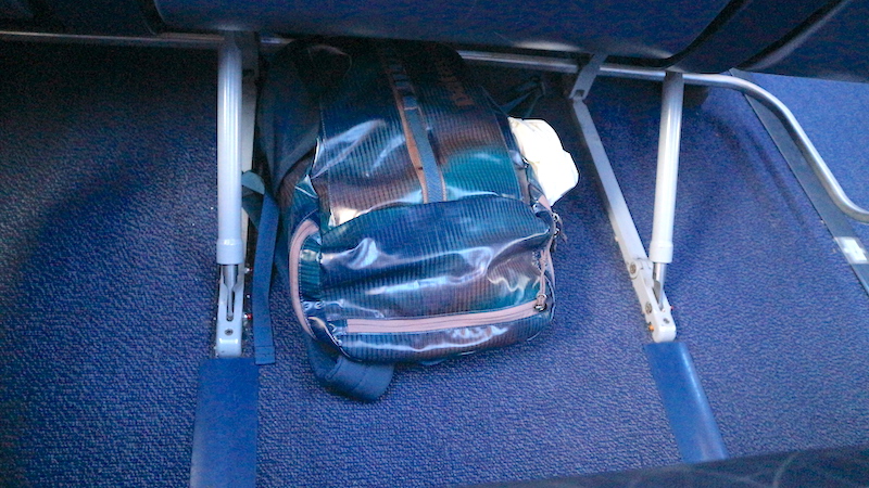 Airplane seat. Carry on bag.